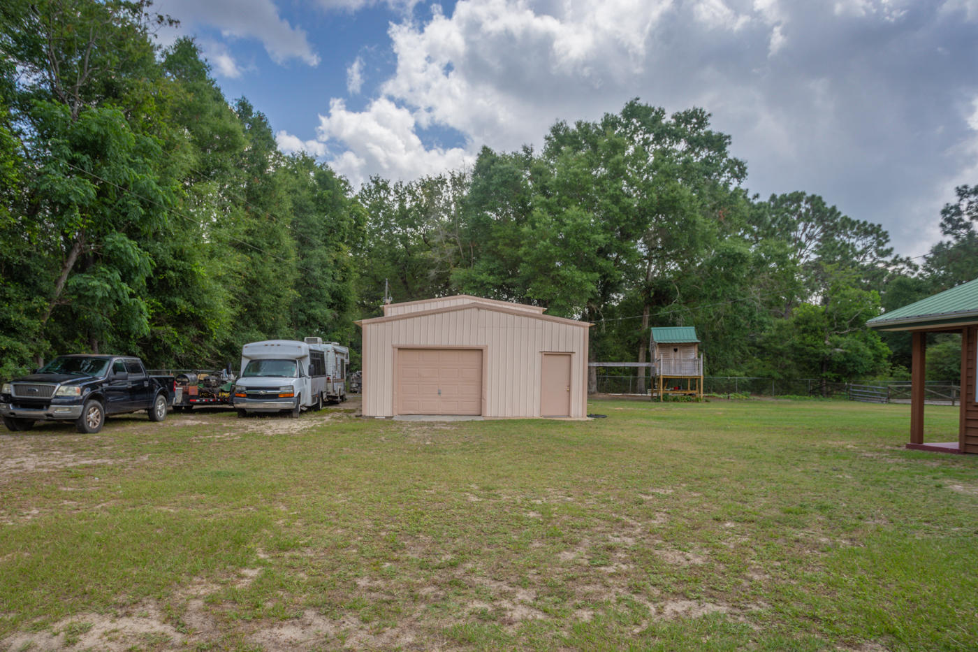 5621 Buckward Road Baker, FL 32531 - Photo 28 of 41 a view of a house with a yard and sitting area