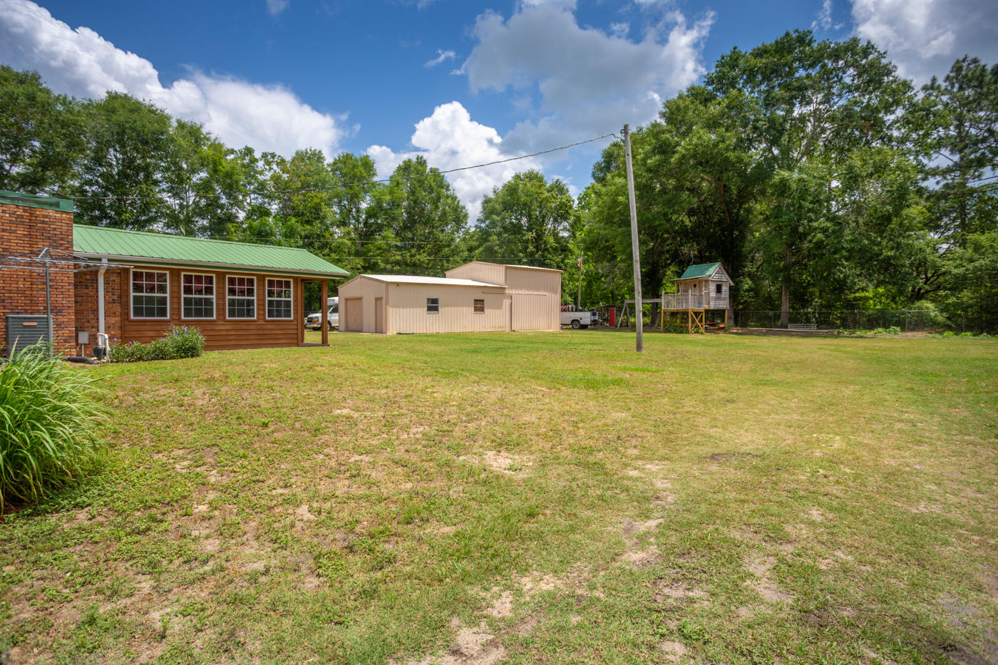 5621 Buckward Road Baker, FL 32531 - Photo 32 of 41 a view of a house with a yard and sitting area