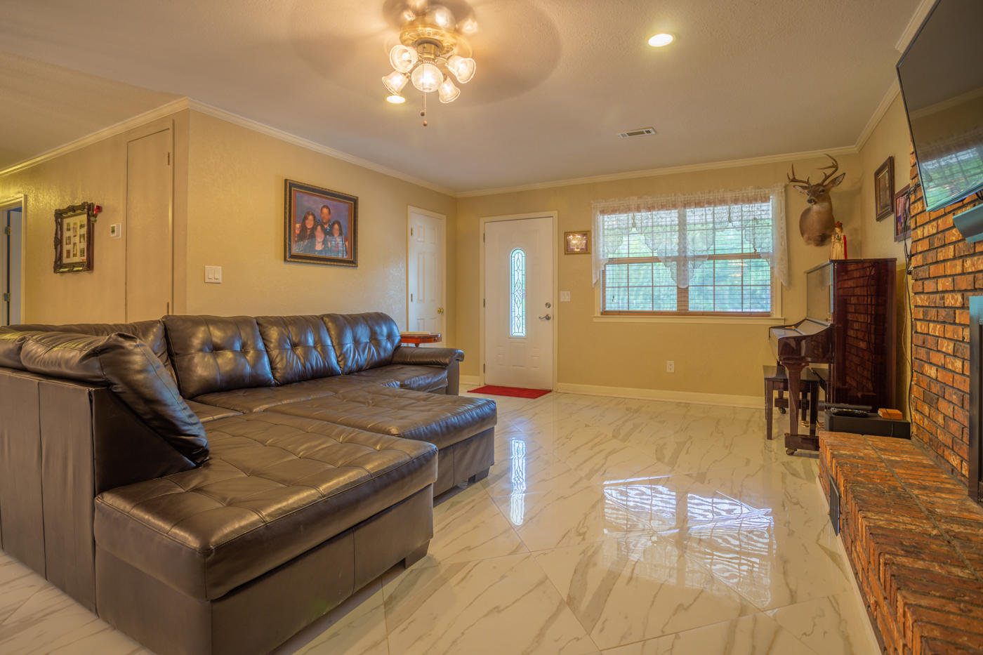 5621 Buckward Road Baker, FL 32531 - Photo 8 of 41 a living room with furniture and a flat screen tv