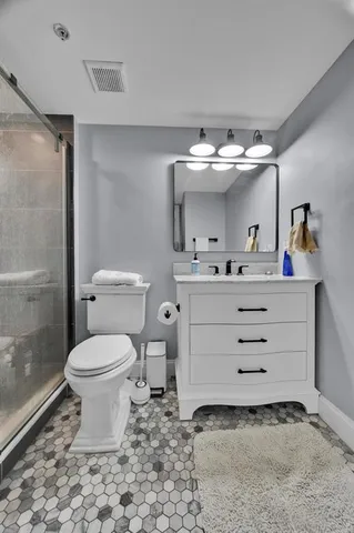 a bathroom with a sink toilet and shower
