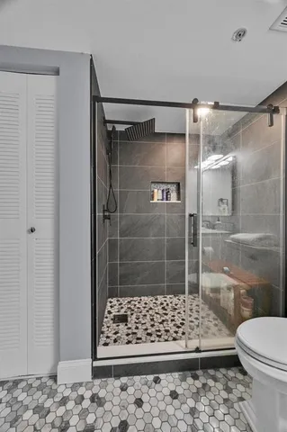 a bathroom with a shower and a toilet