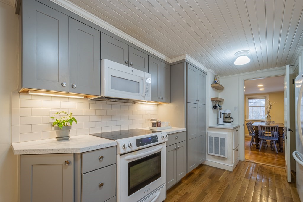 1 Constitution Road Lexington, MA 02421 - Photo 11 of 42 a kitchen with stainless steel appliances granite countertop a sink a stove and cabinets