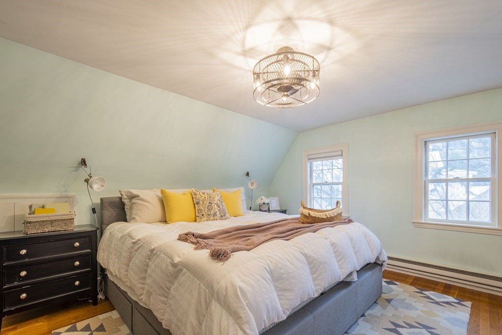 1 Constitution Road Lexington, MA 02421 - Photo 21 of 42 a bedroom with a bed and a chandelier