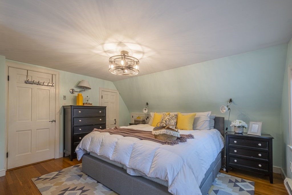 1 Constitution Road Lexington, MA 02421 - Photo 23 of 42 a bedroom with a bed and wooden floor