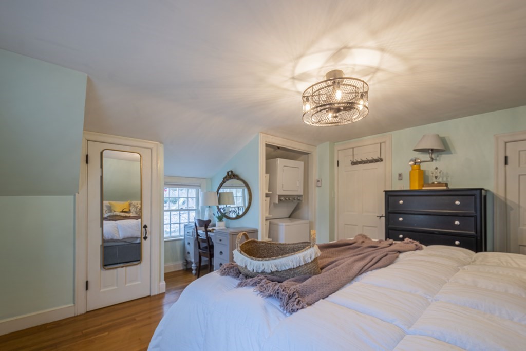 1 Constitution Road Lexington, MA 02421 - Photo 24 of 42 a bedroom with a bed and wooden floor