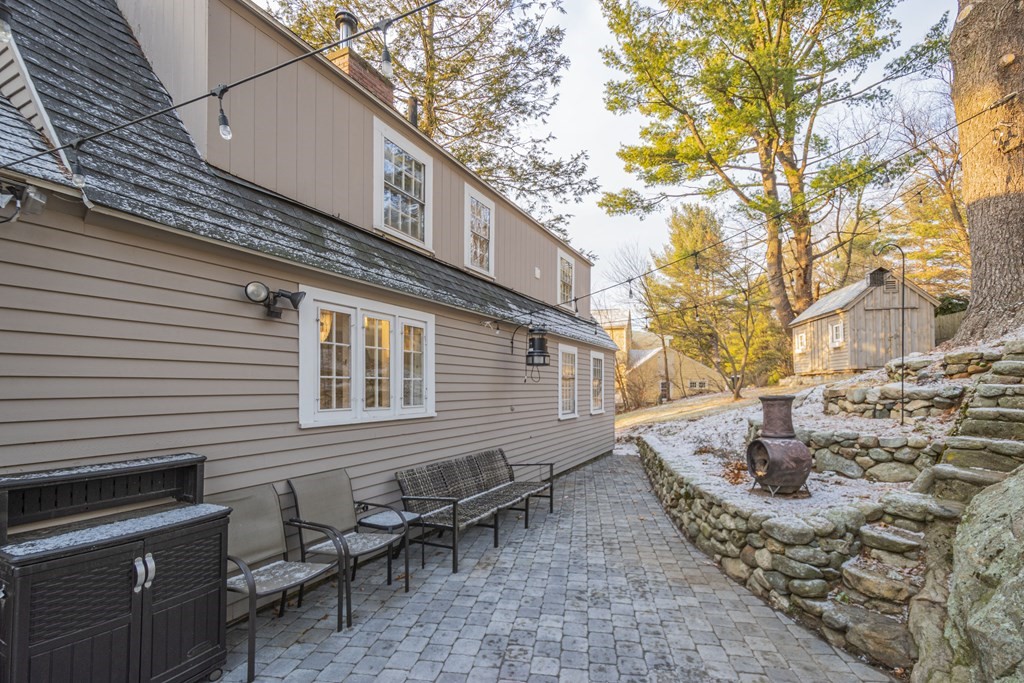 1 Constitution Road Lexington, MA 02421 - Photo 36 of 42 a backyard of a house with table and chairs