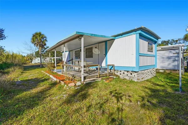 a view of a house with a yard balcony and sitting area