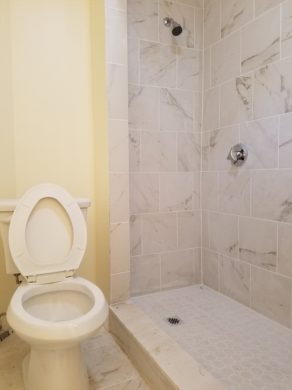 98 Topliff Street Boston, MA 02122 - Photo 11 of 15 a bathroom with a sink a toilet and shower