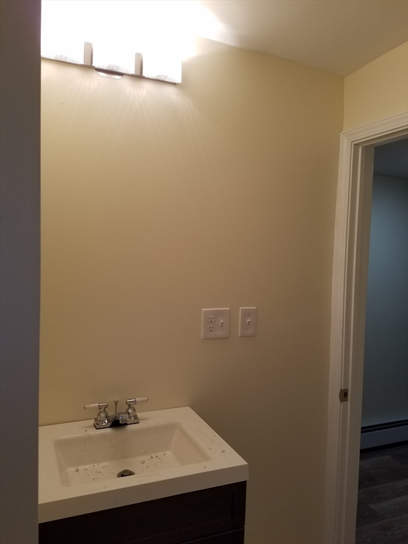 98 Topliff Street Boston, MA 02122 - Photo 12 of 15 a bathroom with a sink and a mirror