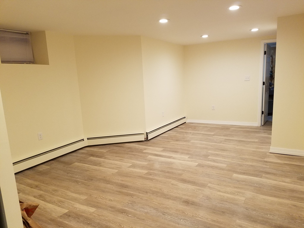98 Topliff Street Boston, MA 02122 - Photo 15 of 15 a view of an empty room with wooden floor