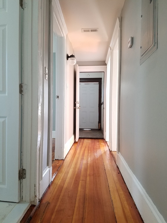 98 Topliff Street Boston, MA 02122 - Photo 6 of 15 a view of a hallway with wooden floor