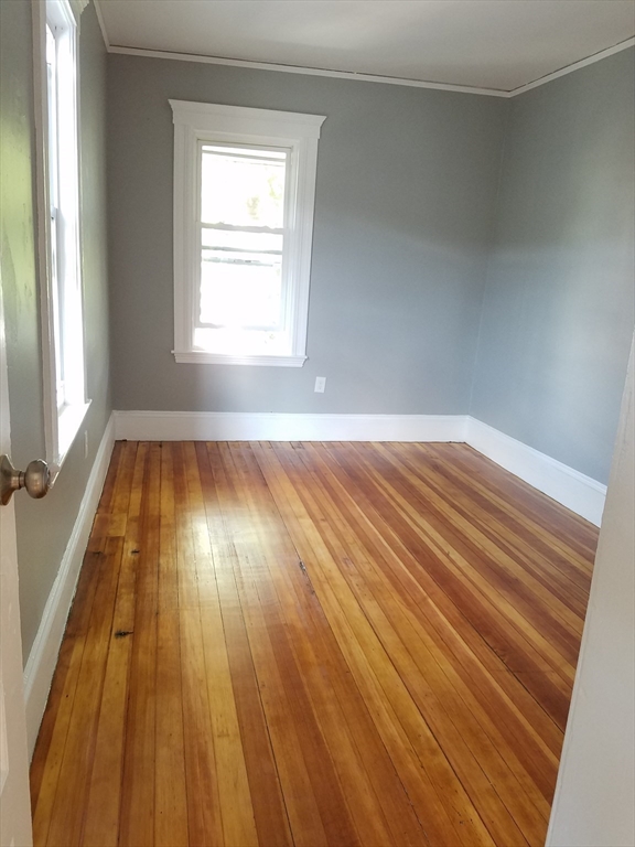 98 Topliff Street Boston, MA 02122 - Photo 8 of 15 a view of an empty room and wooden floor