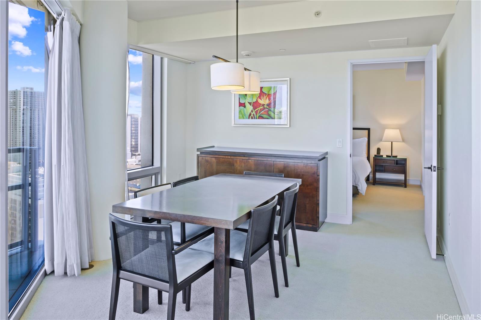 223 Saratoga Road, Unit 2601 Honolulu, HI 96815 - Photo 14 of 23 a dining room with a table and chairs