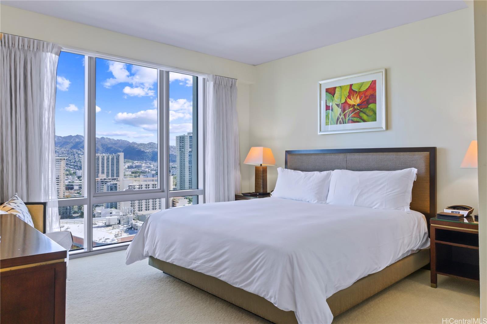223 Saratoga Road, Unit 2601 Honolulu, HI 96815 - Photo 16 of 23 a bedroom with a large bed and a large window