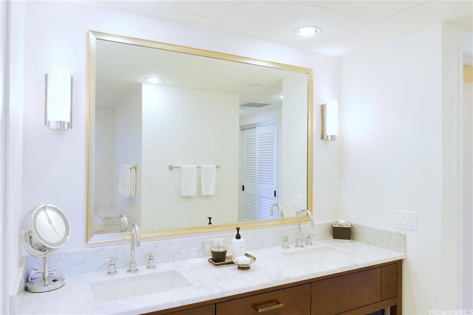 223 Saratoga Road, Unit 2601 Honolulu, HI 96815 - Photo 18 of 23 a bathroom with a granite countertop sink and a mirror