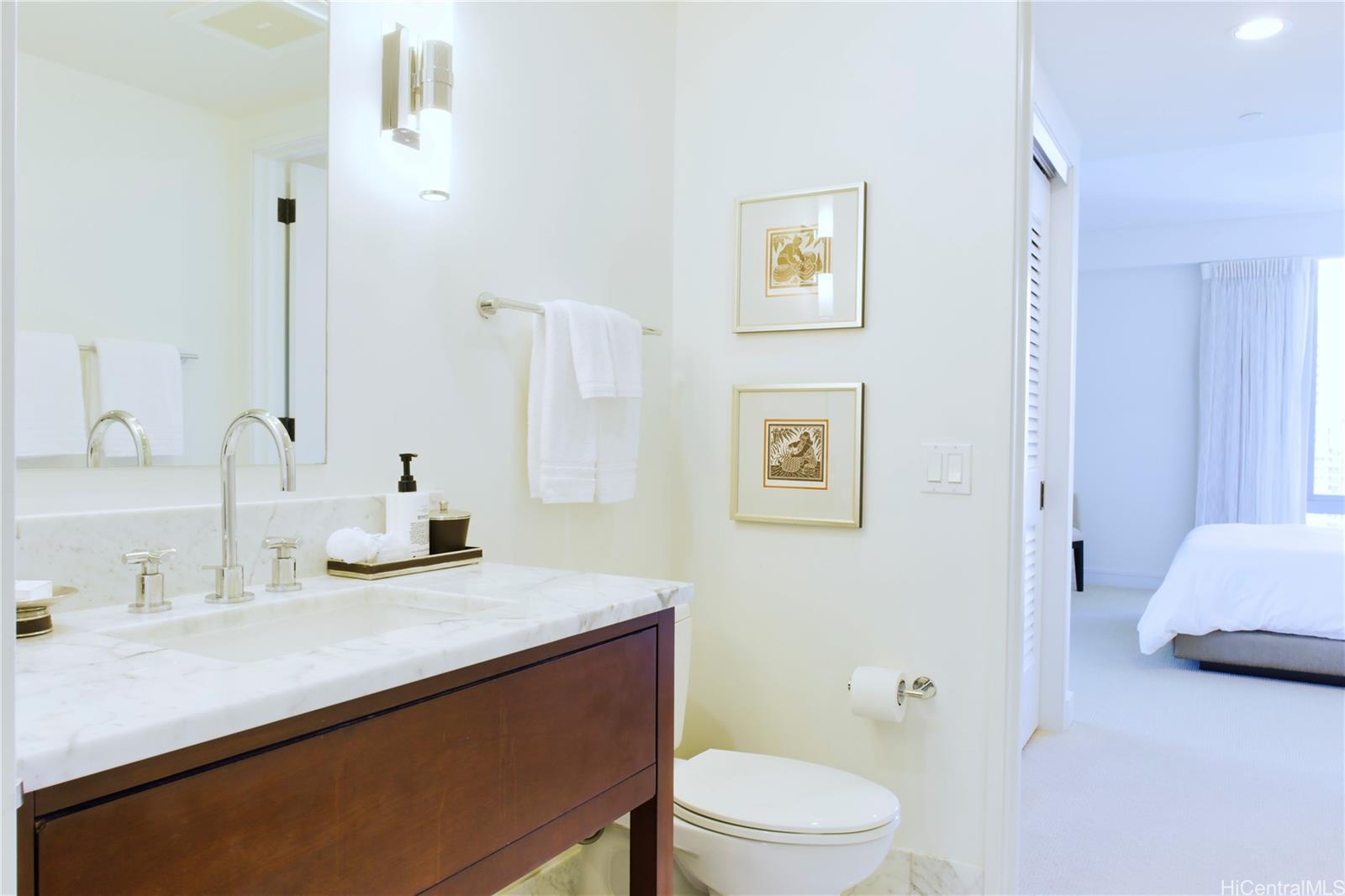 223 Saratoga Road, Unit 2601 Honolulu, HI 96815 - Photo 22 of 23 a bathroom with a sink a toilet and shower