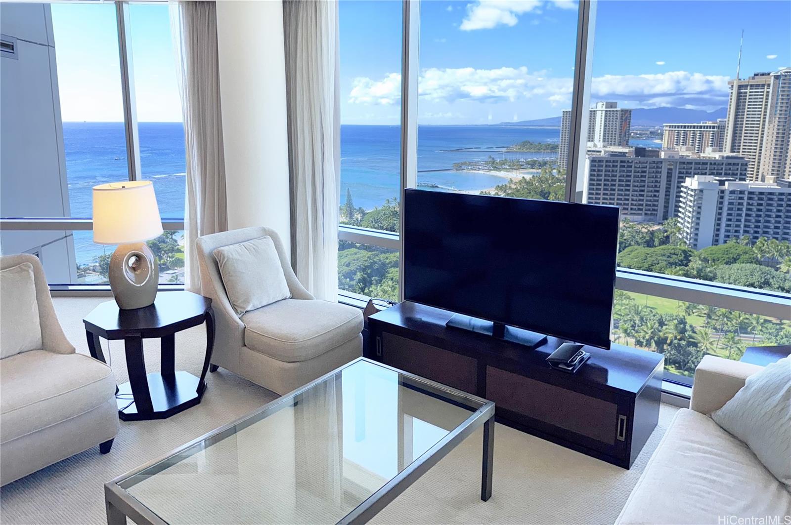 223 Saratoga Road, Unit 2601 Honolulu, HI 96815 - Photo 6 of 23 a living room with furniture a lamp and a floor to ceiling window