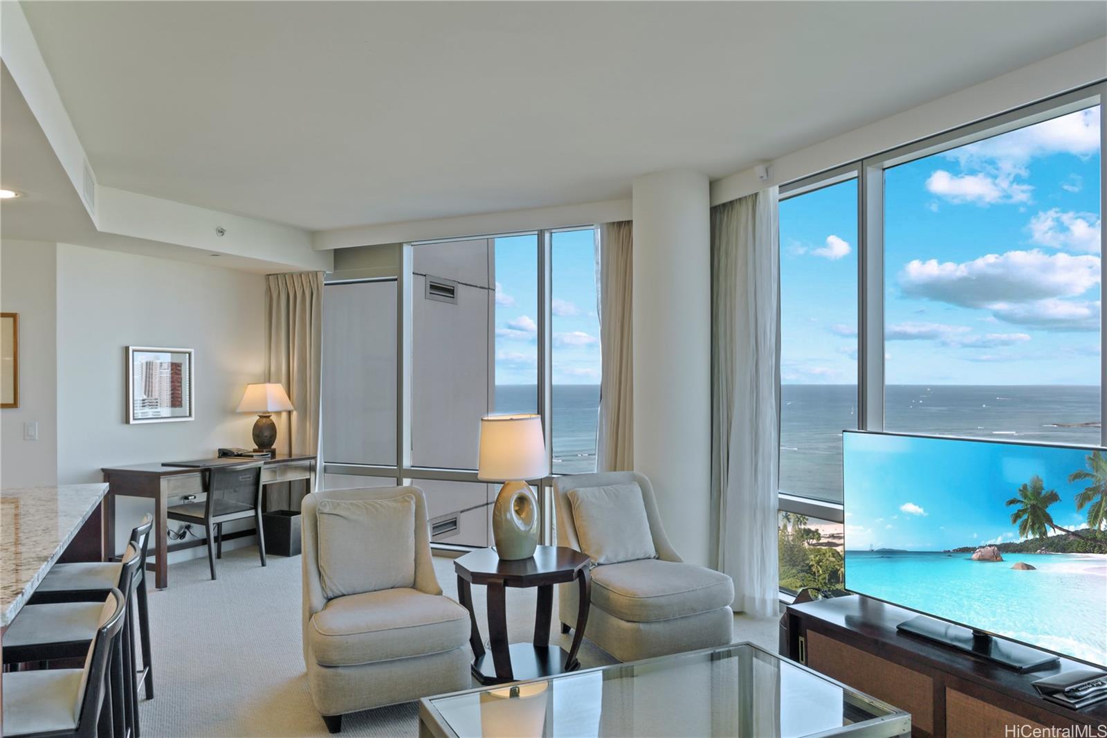 223 Saratoga Road, Unit 2601 Honolulu, HI 96815 - Photo 7 of 23 a living room with furniture and wooden floor