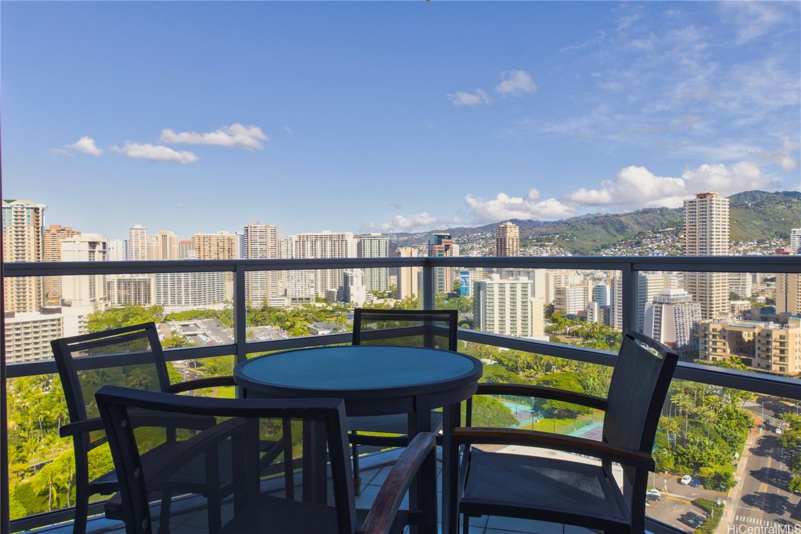 223 Saratoga Road, Unit 2601 Honolulu, HI 96815 - Photo 9 of 23 a view of a balcony with chairs and a table