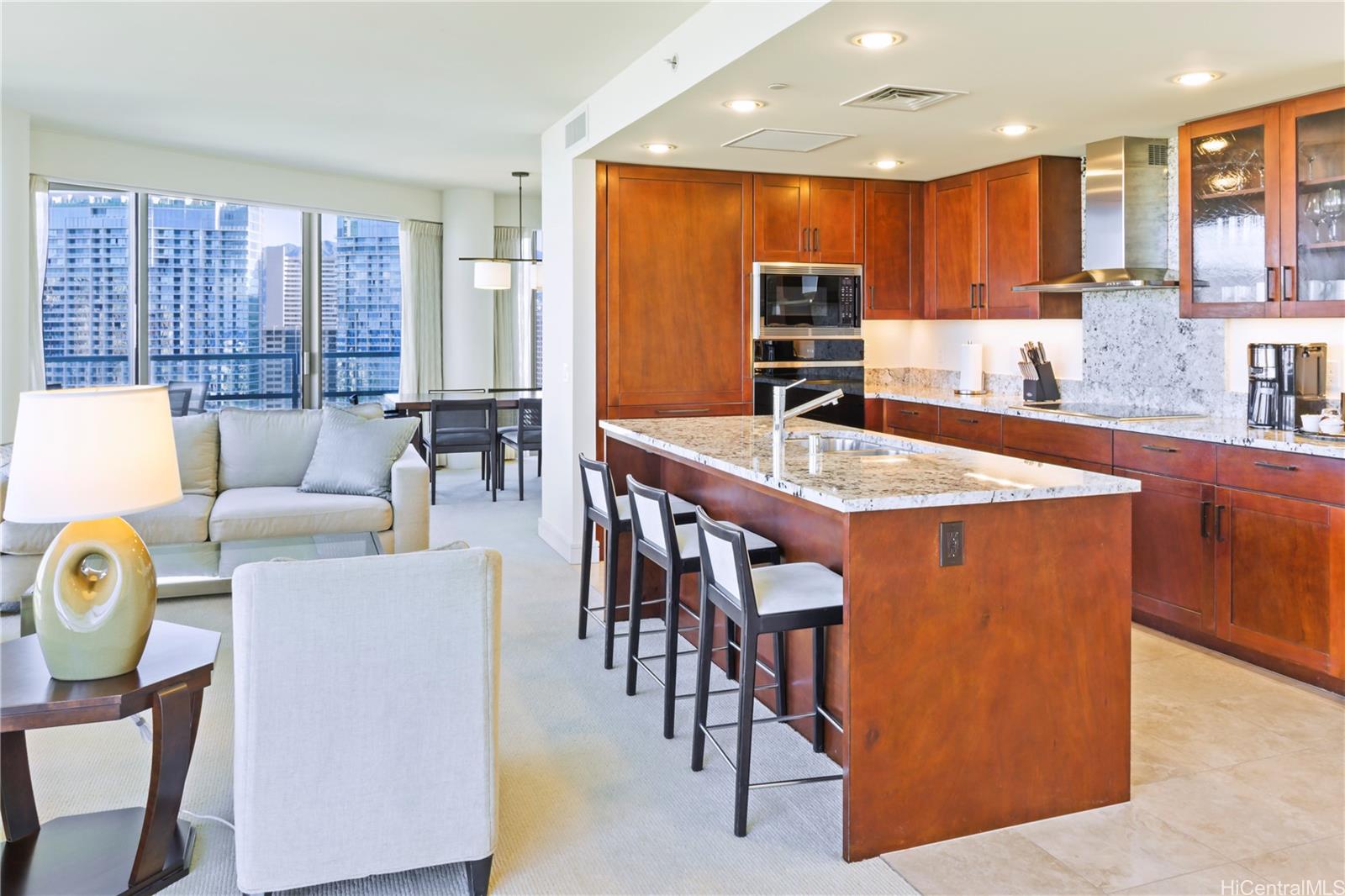 223 Saratoga Road, Unit 2601 Honolulu, HI 96815 - Photo 10 of 23 a large kitchen with a table and chairs