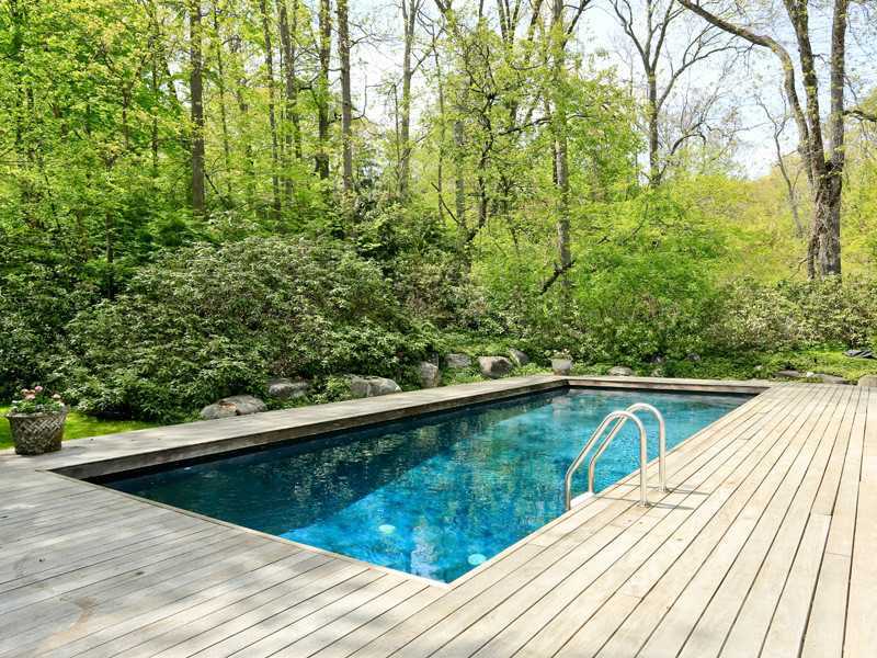 496 Valley Road Cos Cob, CT 06807 - Photo 11 of 14 a view of swimming pool with a large pool and large trees