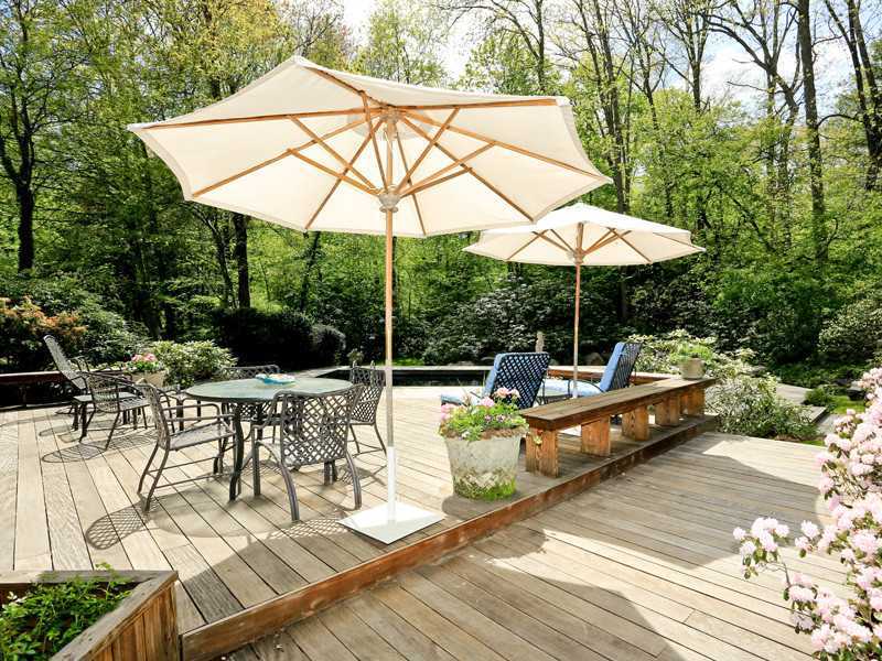 496 Valley Road Cos Cob, CT 06807 - Photo 13 of 14 a view of patio with chairs and table under an umbrella