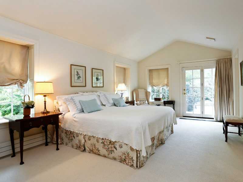 496 Valley Road Cos Cob, CT 06807 - Photo 8 of 14 a spacious bedroom with a bed and a large window