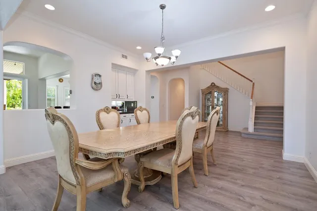 a view of a dining room with furniture and wooden floor