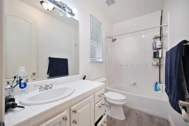 a bathroom with a sink toilet tub and shower
