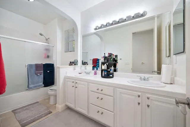 a spacious bathroom with a double vanity sink mirror and double