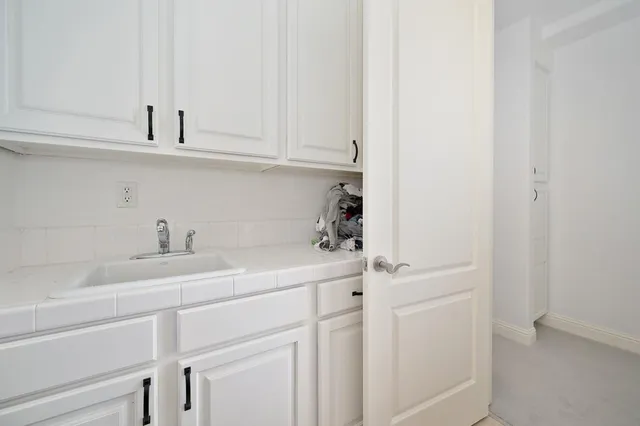 a kitchen with a sink and cabinets