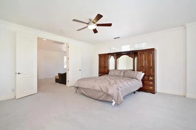 a bedroom with a bed and dresser