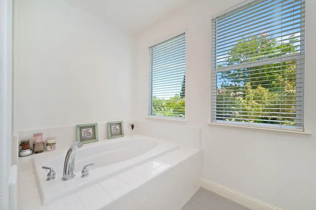 a bathroom with bathtub and window