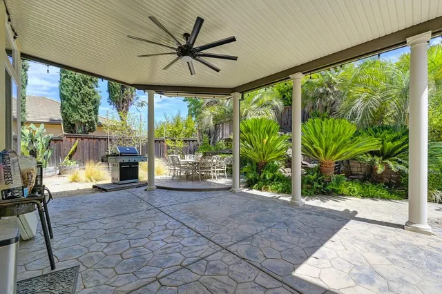 a view of a porch with furniture and a yard
