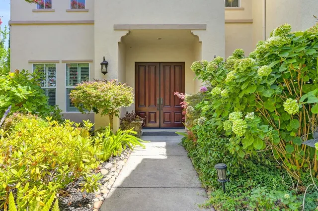 a front view of a house with a yard and flowers