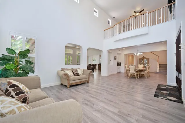 a living room with furniture and wooden floor