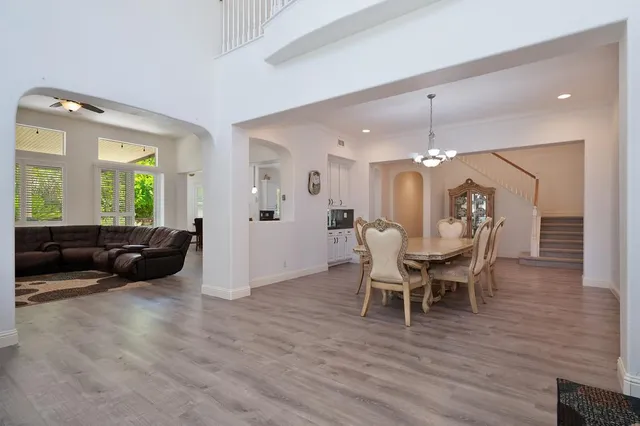a view of a dining room with furniture and wooden floor