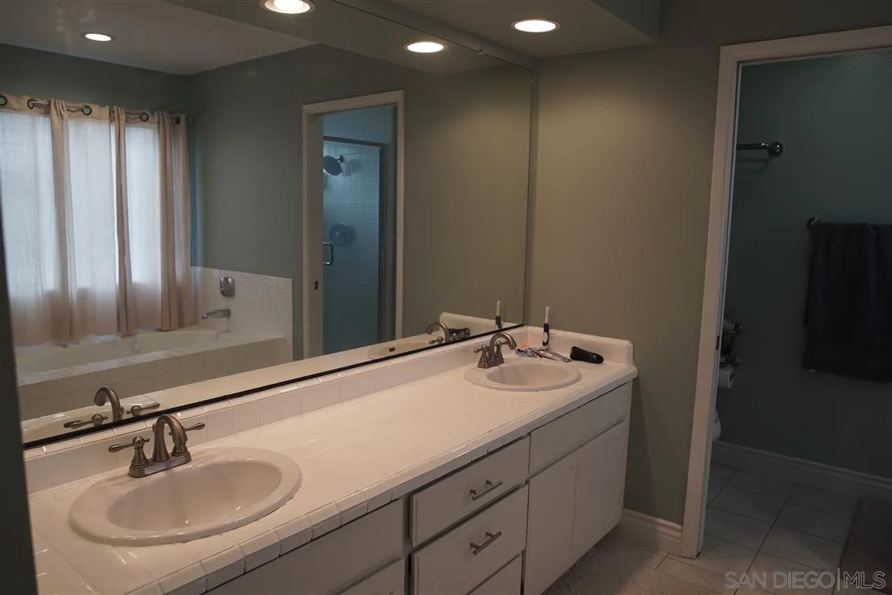 12701 Triumph Drive Poway, CA 92064 - Photo 13 of 21 a bathroom with a sink and a mirror
