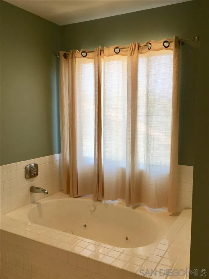 12701 Triumph Drive Poway, CA 92064 - Photo 14 of 21 a bathroom with a shower and a bathtub