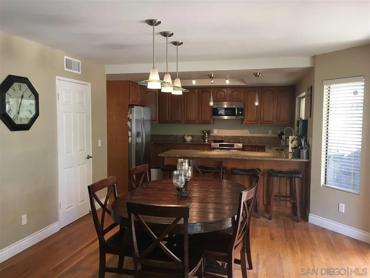 12701 Triumph Drive Poway, CA 92064 - Photo 15 of 21 a kitchen with a dining table and chairs