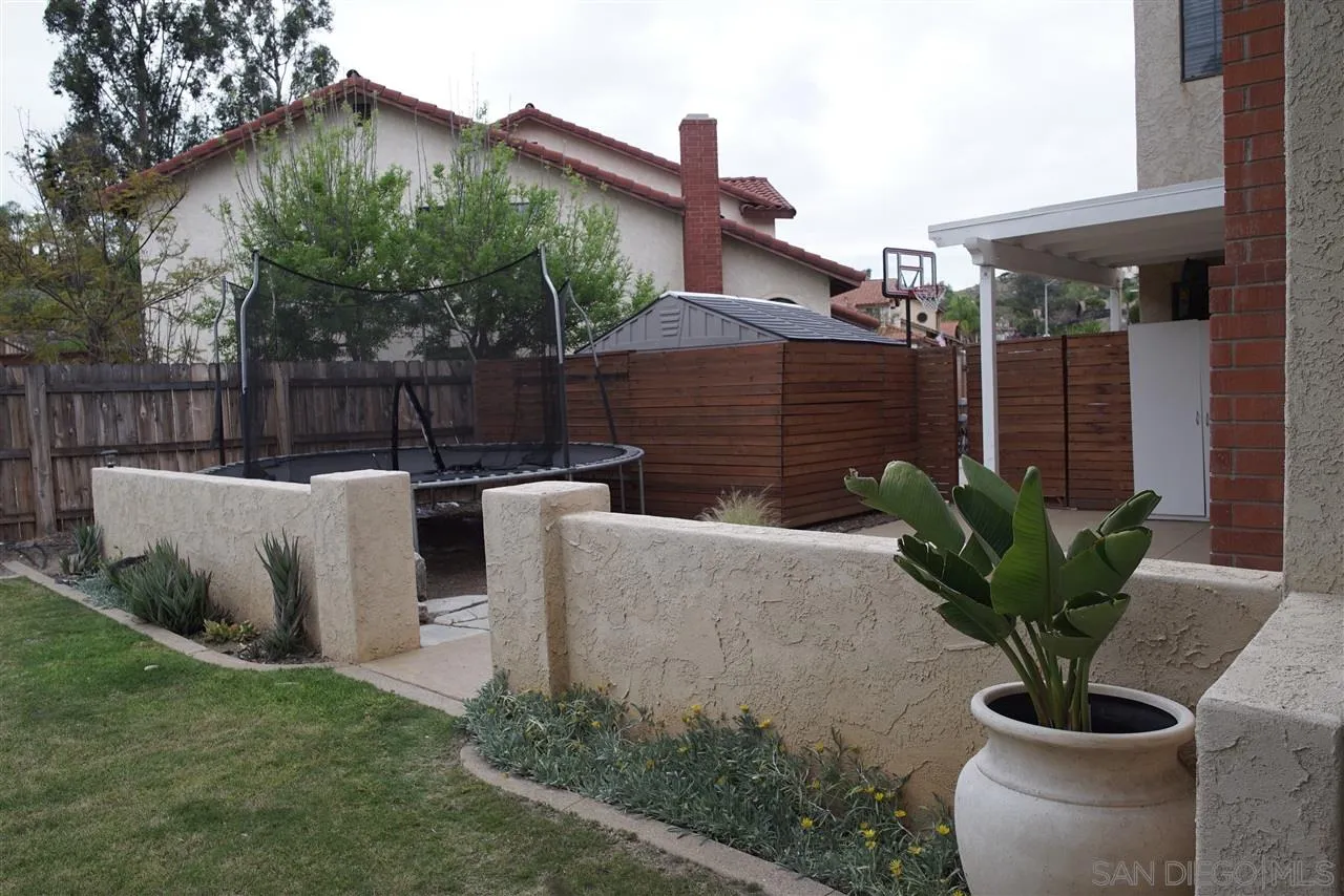 12701 Triumph Drive Poway, CA 92064 - Photo 8 of 21 a view of a chairs and table in the backyard