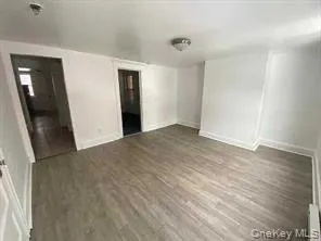 a view of hallway with wooden floor