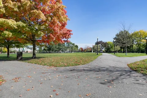 a view of a swimming pool with a patio and a yard