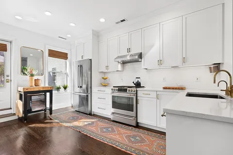 a kitchen with a sink cabinets and stainless steel appliances