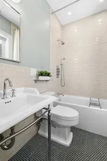 a bathroom with a sink toilet a mirror and shower