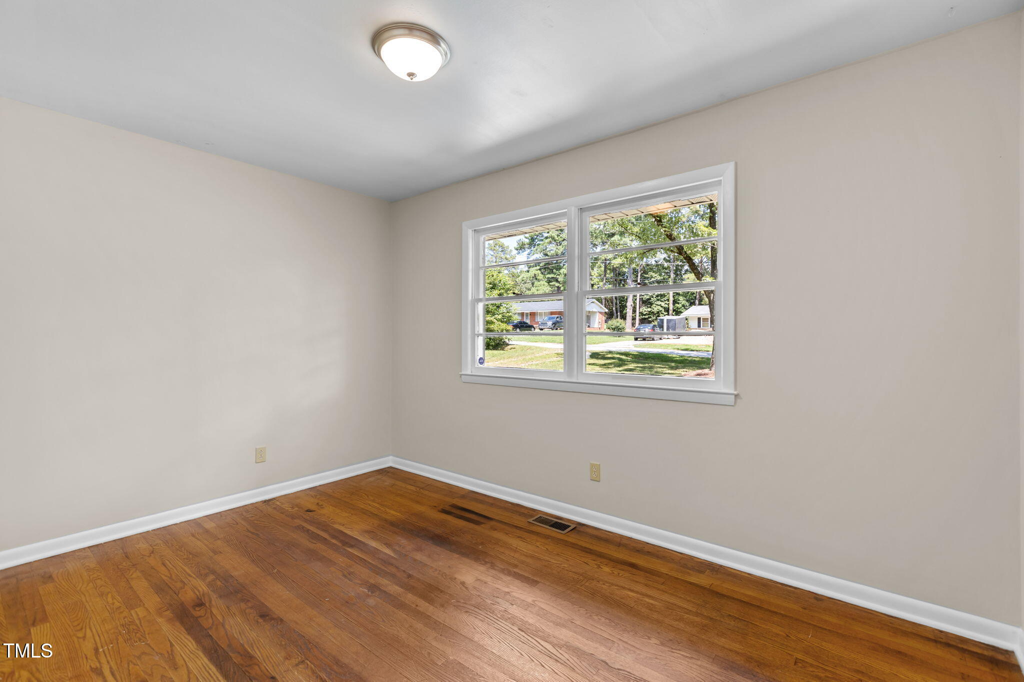 912 Williams Road Raleigh, NC 27610 - Photo 14 of 19 an empty room with wooden floor and windows