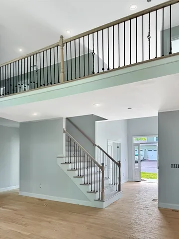 a hallway with wooden floor in front of a house