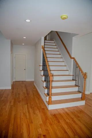 a view of a room with wooden floor and stairs