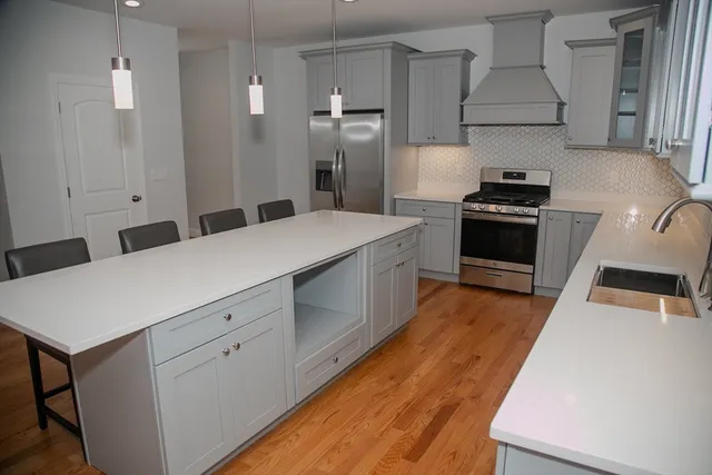 a kitchen with a stove a sink and a refrigerator