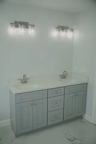 a bathroom with a double vanity sink and a mirror